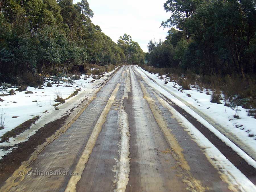 Muddy gravel with slush on the road to Lake Crescent, central Tasmania